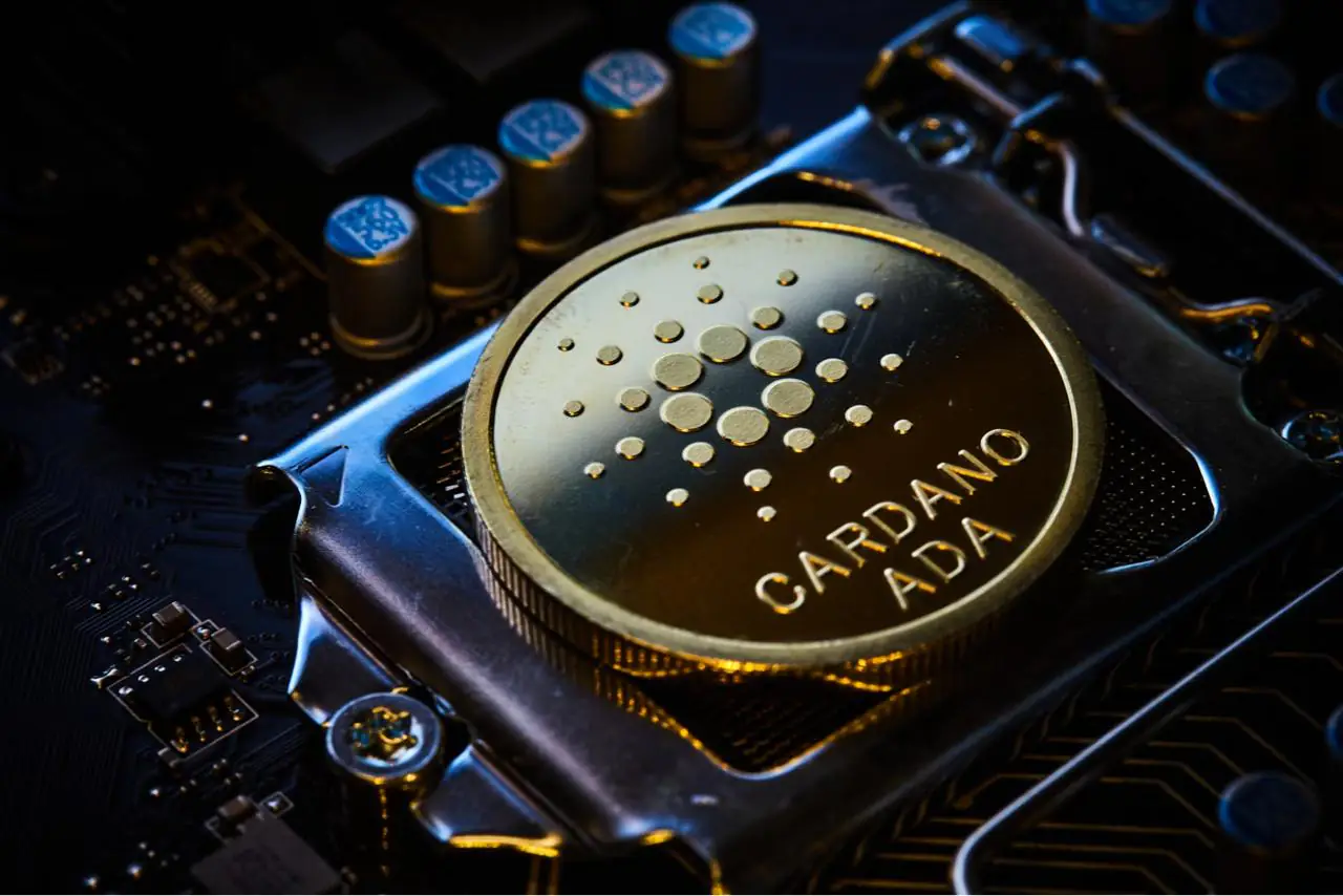 Cardano ADA coin on a computer chip representing AI forecast and blockchain expansion