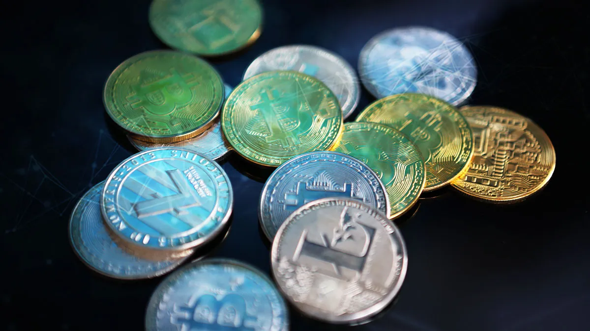 Assorted cryptocurrency coins including Bitcoin facing market volatility due to global geopolitical tensions