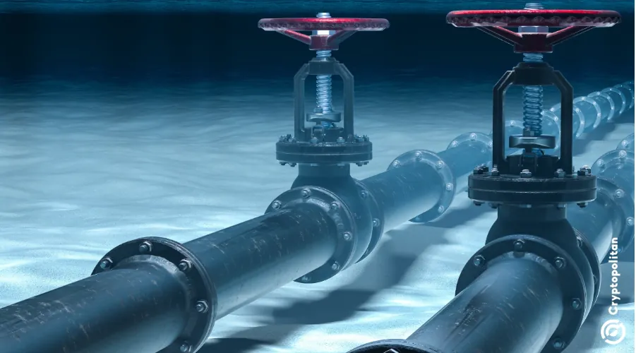 High-pressure underwater oil pipeline valves with red handles, shown at ocean floor level