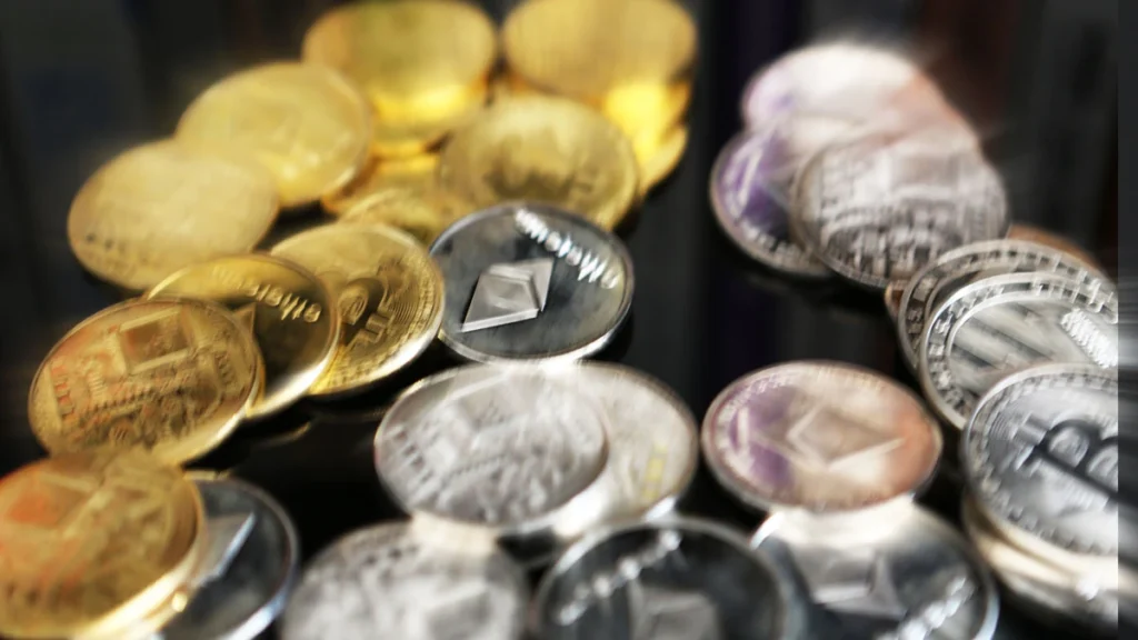 Collection of gold and silver cryptocurrency coins symbolizing Aptos crypto surge and leadership in RWA tokenization