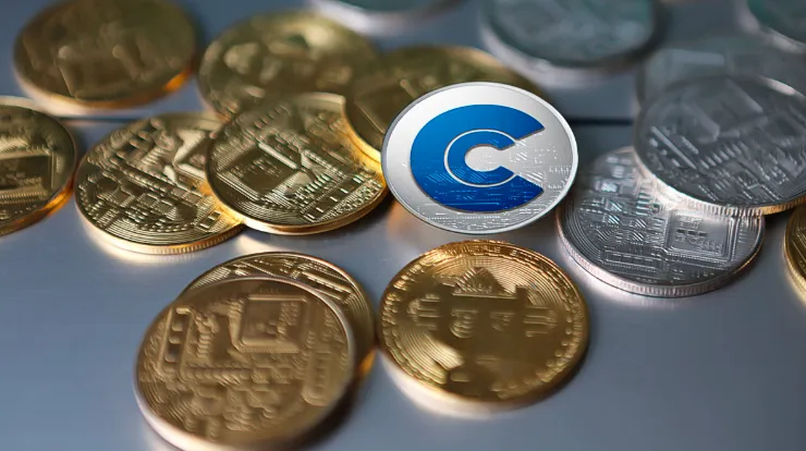 Image of a cryptocurrency coin with a "C" symbol, surrounded by other digital coins.