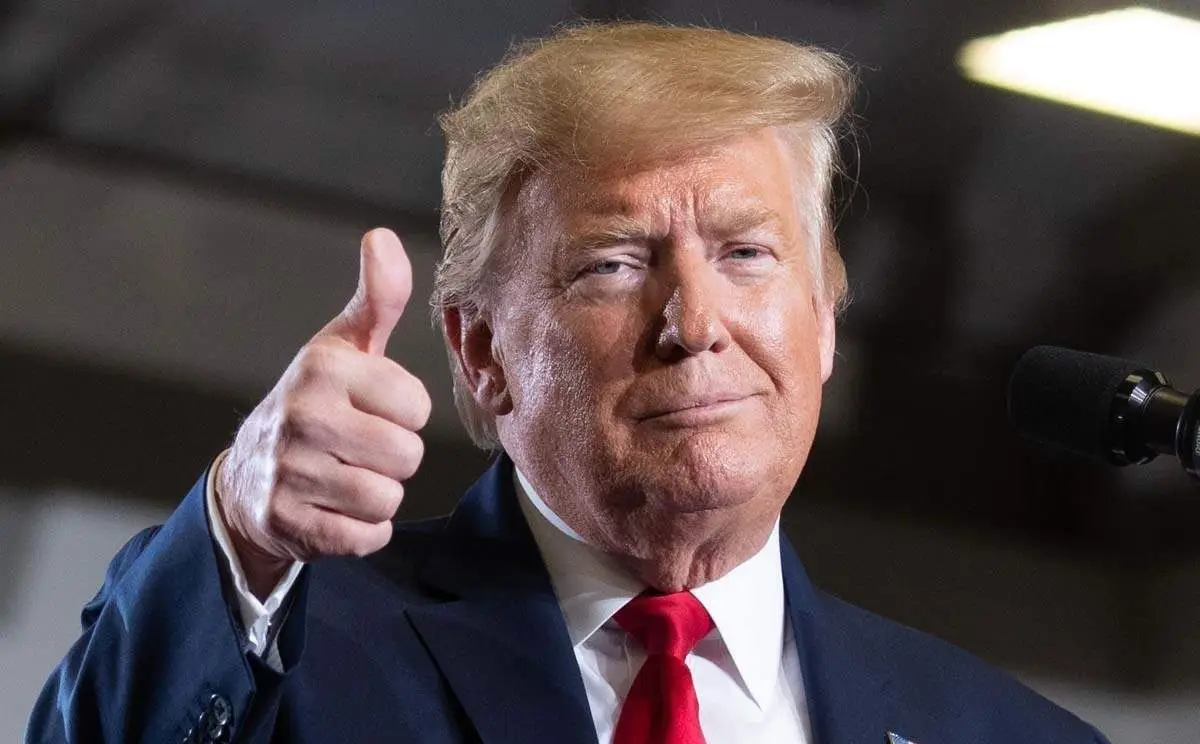 Donald Trump giving a thumbs-up during a speech