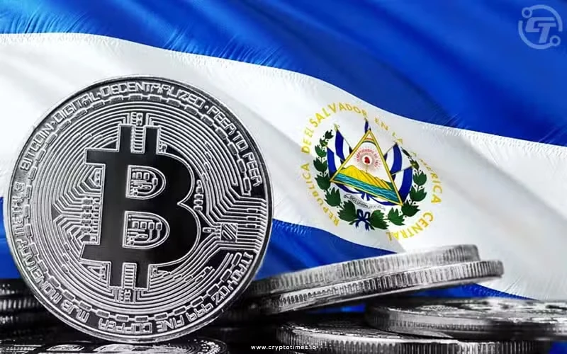 Bitcoin coins stacked in front of the El Salvador national flag representing the country’s cryptocurrency adoption
