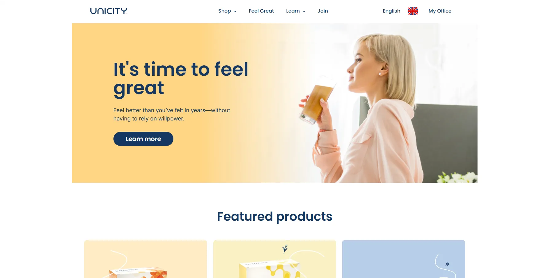 Screenshot of Unicity homepage showing a woman drinking Feel Great beverage with tagline It's time to feel great