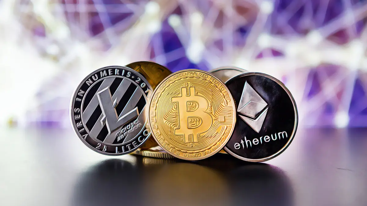 Bitcoin, Ethereum, and Litecoin coins displayed as crypto funds face major outflows