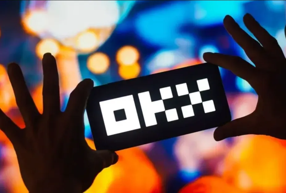 OKX exchange logo displayed on a phone screen, highlighting the launch of USDT-margined perpetual futures for DASH and ZEC.