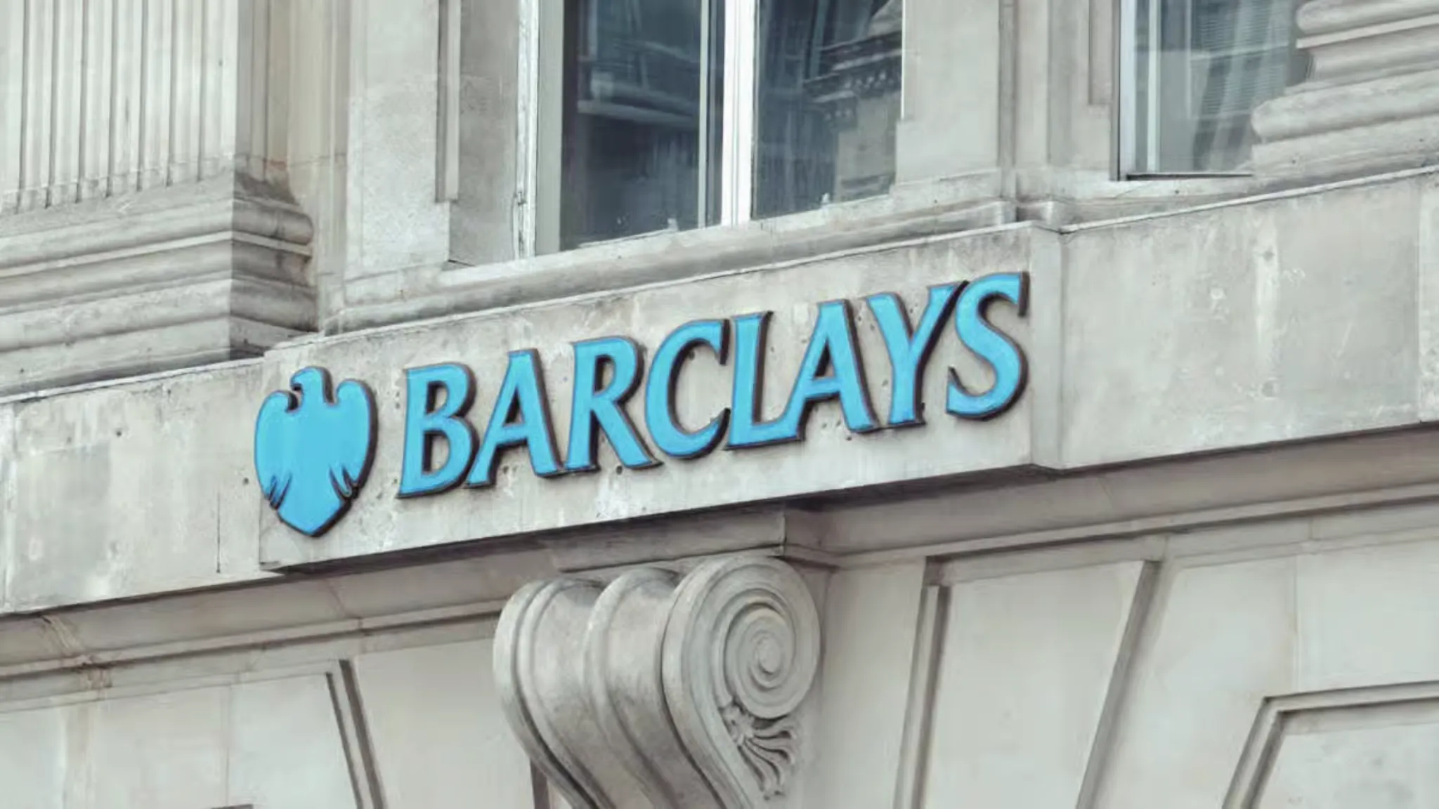Barclays bank building exterior showcasing company logo related to blockchain settlement tools exploration