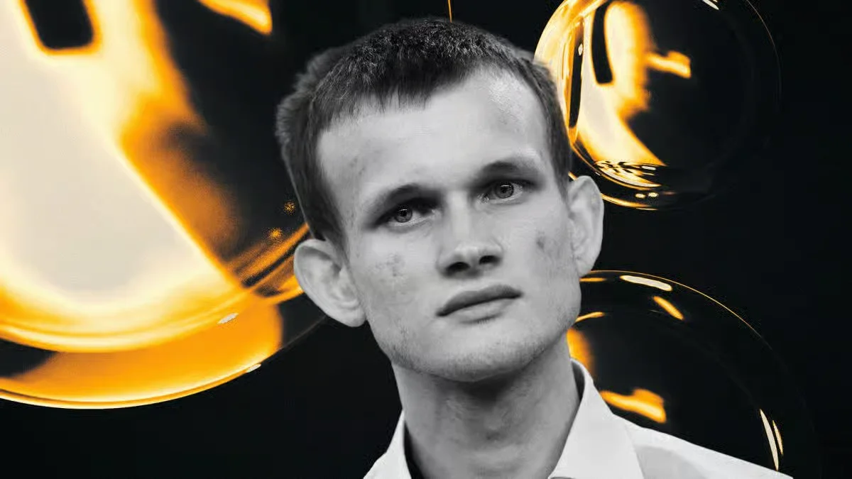 Monochrome portrait of Vitalik Buterin in a white shirt with glowing golden abstract bubble shapes on a black background.